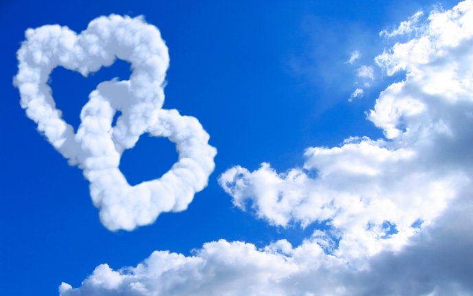 Two hearts mated - formed ​​of clouds on the sky