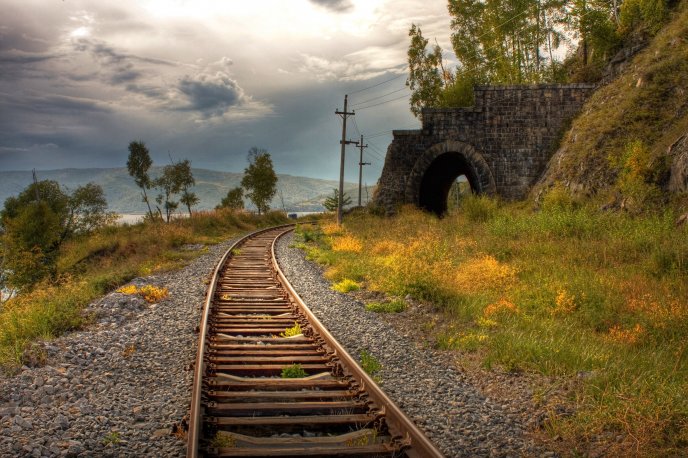 Old rails entering in a tunnel - HD nature landscape