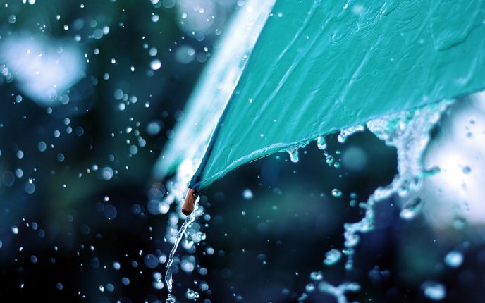Macro water drops on the blue umbrella - beautiful rainy day