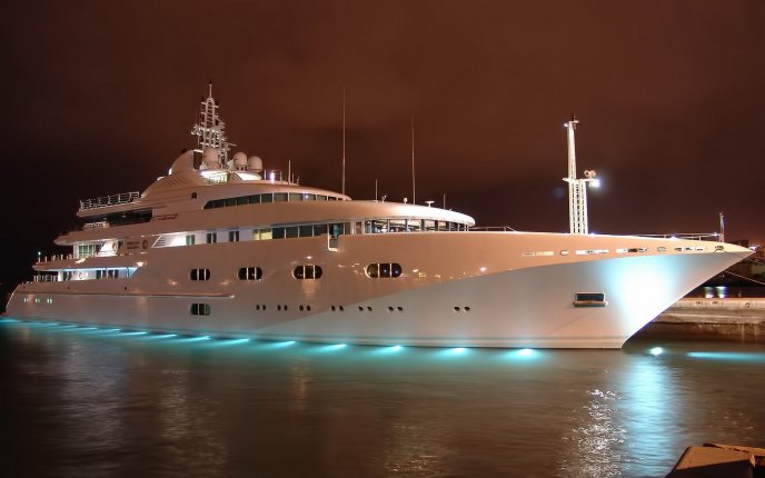 Beautiful white yacht lighted on the water in the night