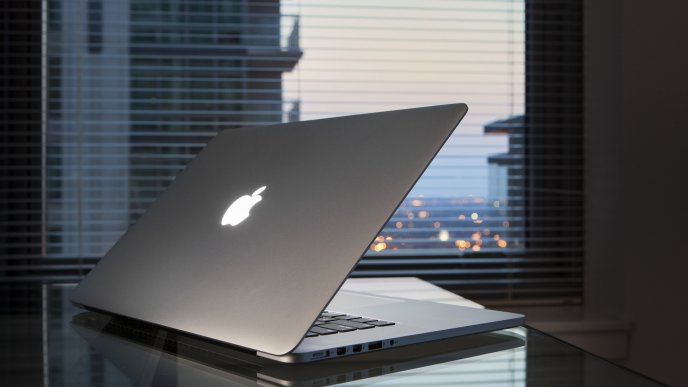 Gray Apple MacBook on a table - Apple wallpaper