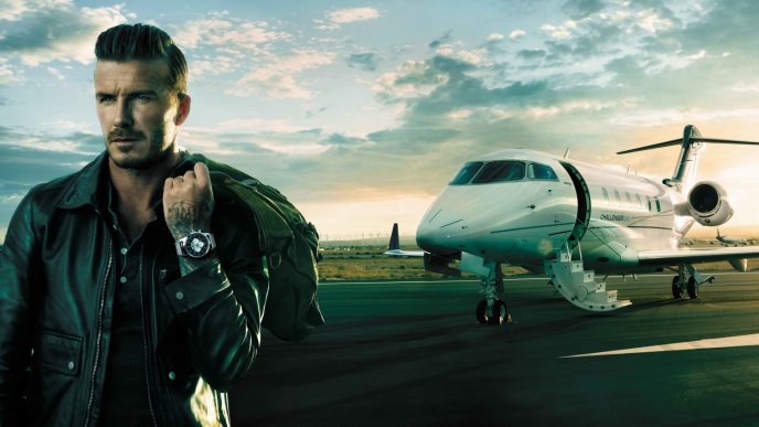 David Beckham on the airport near an airplane
