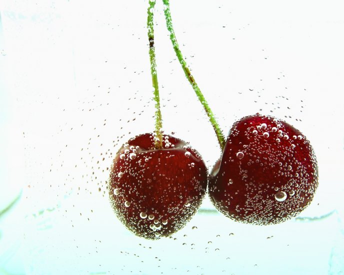 Two cherries in mineral water - bubbles