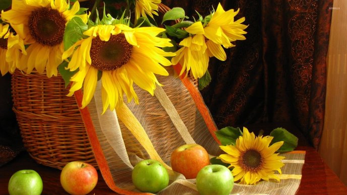 Sunflowers in a bascket and delicious summer apples