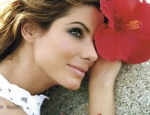 Sandra Bullock with a beautiful red flower