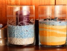 Colored candles in jars with sand