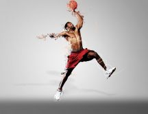 Basketball player throwing the ball to the basket