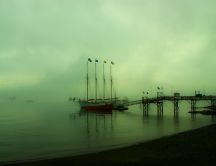 Fog on the sea - boat moored at pier