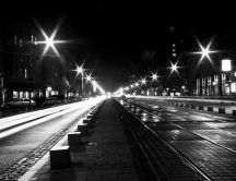 Street and sidewalk illuminated at night