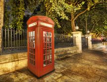 Red telephone booth on the sidewalk in London HD wallpaper