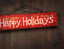 Happy Holidays written on a piece of wood