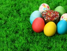 Easter eggs and a cupcake on the grass