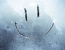 Smiley face on a frozen window