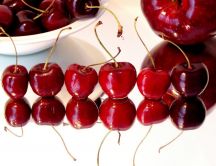 Cherries on a glass table - mirror on the floor
