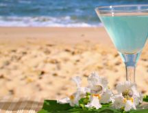Blue summer cocktail at the beach