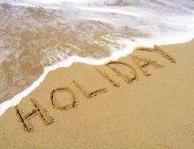Summer holiday at seaside - message on the sand