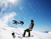 Winter sports on a sunny day - snowboard jumping