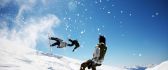 Winter sports on a sunny day - snowboard jumping