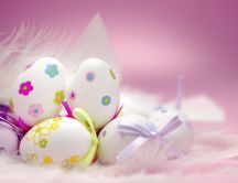 White eggs with beautiful drawings on the pink background