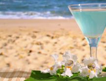 Blue fresh summer cocktail at the beach