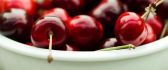Shiny cherries in a white bowl - prepare for a movie
