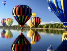 Colored hot air balloons over the lake