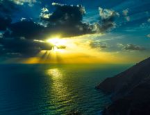 Sunset over the sea - Sunrays between the clouds