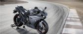 Gray and red Yamaha YZF R1 motorcycle on road