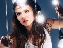 Victoria Dawn Justice poses between many bulbs