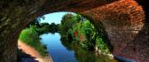 A river under an arched bridge - Nature wallaper