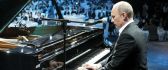 Vladimir Putin playing piano in a concert
