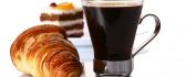 Delicious breakfast - croissant and dark coffee
