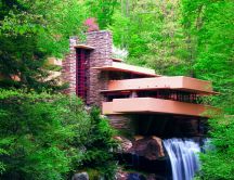 Modern house in the middle of the forest - waterfall inside