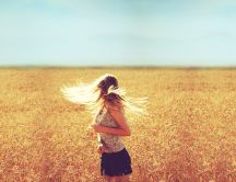 Girl with beautiful blonde hair in the golden wheat field