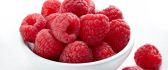 Cup full with delicious raspberries - summer vitamins