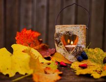 Warm light in a wooden candle - Autumn time