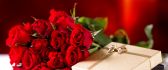 Golden gift box and a wonderful bouquet of red roses