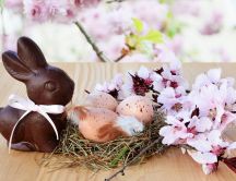 Chocolate Easter bunny and a nest with eggs - Happy Holiday