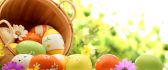 Wooden basket full with colorful Easter eggs - Spring season