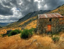 Small house made from rocks in the mountains - Nature view
