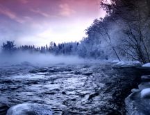 Fog over the cold mountain river in winter season