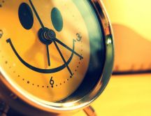 Smiley face on a happy clock - The alarm rings wake up now