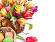 Spring beautiful flowers and Easter painted eggs in a basket
